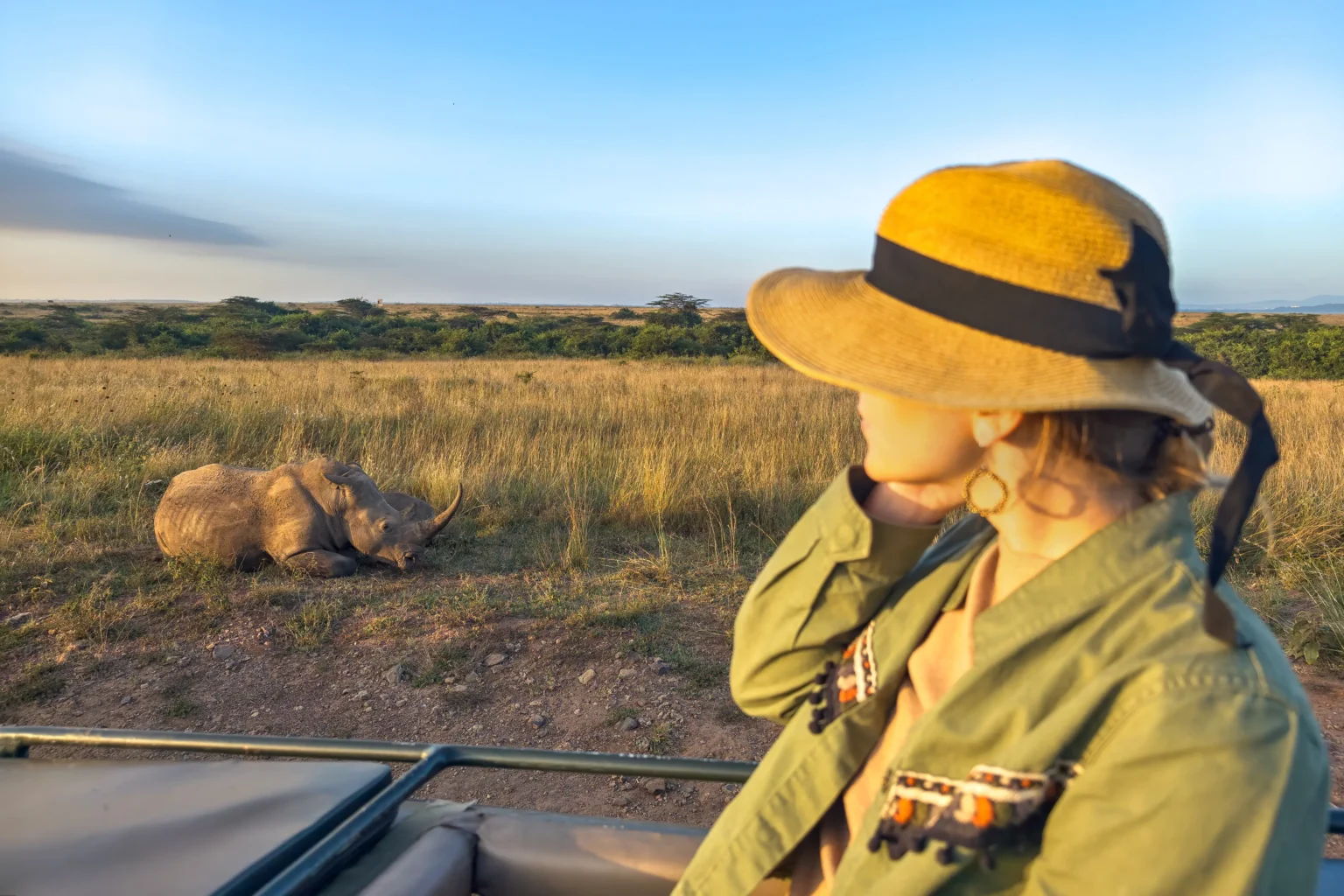 safari holiday wildlife photography kenya tanzania blond woman watching african elephants from roof safari car family safari holiday amboseli national park scaled